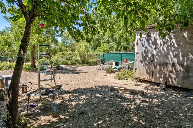 a view of backyard with a table and chairs