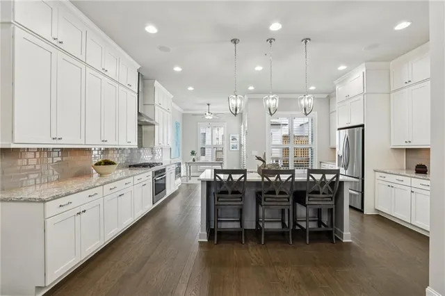 a large kitchen with cabinets table and chairs