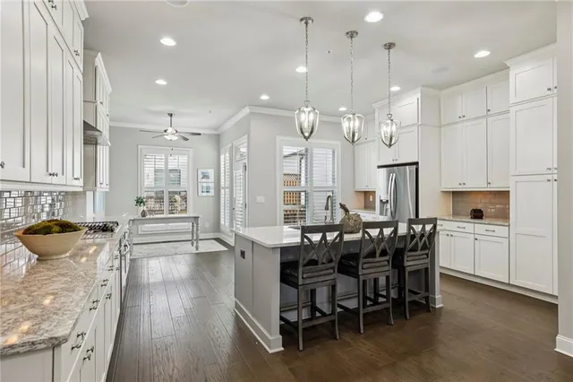 a large kitchen with cabinets table and chairs