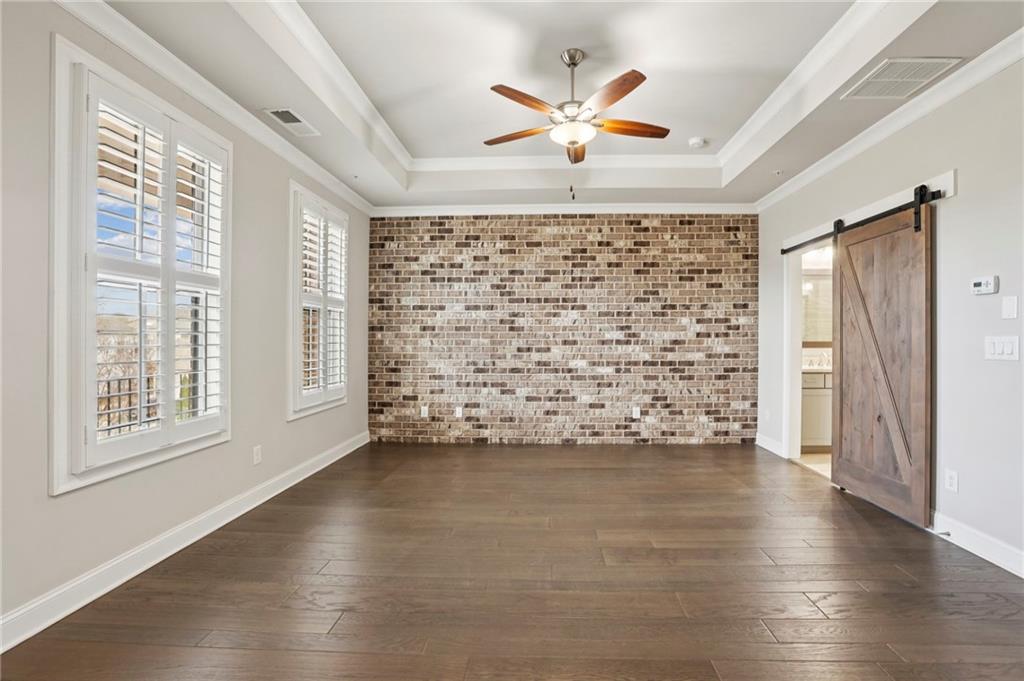 355 Cricket Lane Alpharetta, GA 30009 - Photo 19 of 39 a view of an empty room with a window and wooden floor