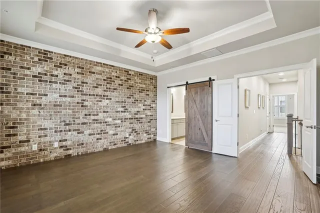 a view of a livingroom with wooden floor and a ceiling fan