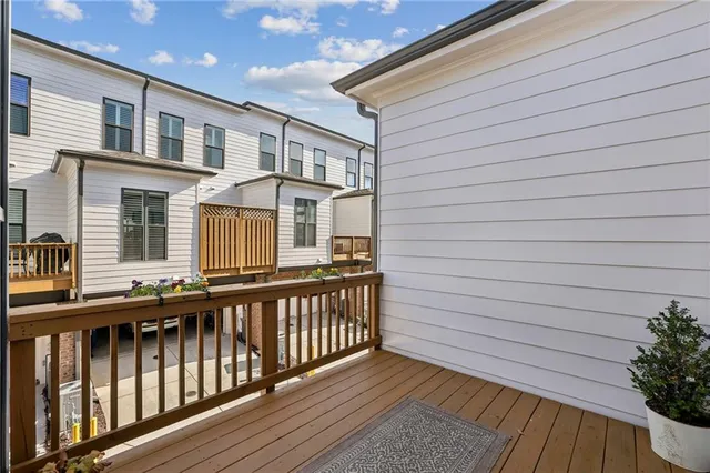a view of a brick house with roof deck