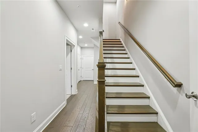 a view of entryway and gallery with wooden floor