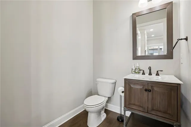 a bathroom with a toilet a sink and mirror