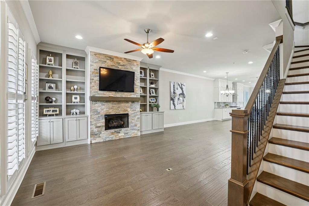 355 Cricket Lane Alpharetta, GA 30009 - Photo 4 of 39 a living room with furniture a flat screen tv and a fireplace