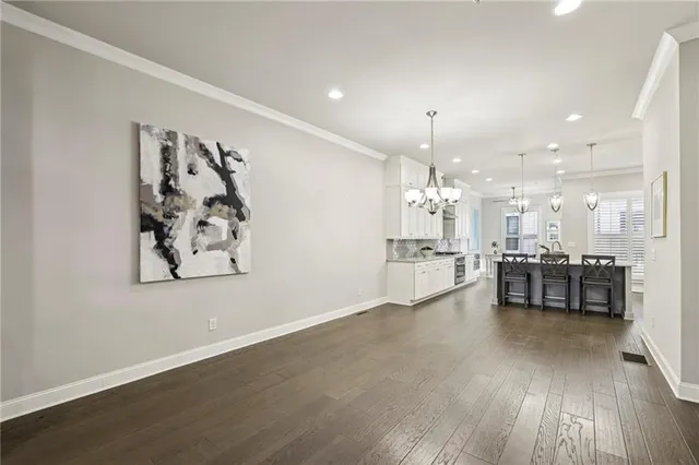 a view of a kitchen with furniture and wooden floor