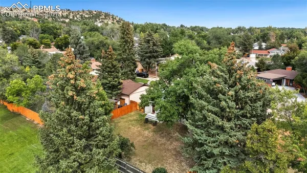 an aerial view of a house with a yard