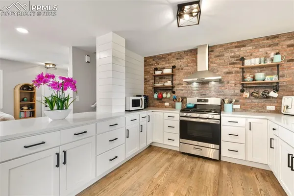 a kitchen with granite countertop a sink stainless steel appliances and cabinets