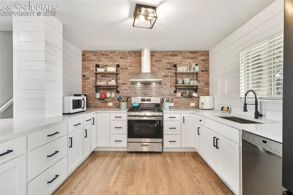 a kitchen with stainless steel appliances a white cabinets and sink