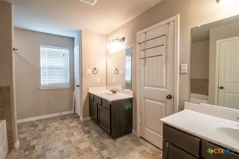 a room with a stove a sink and a refrigerator