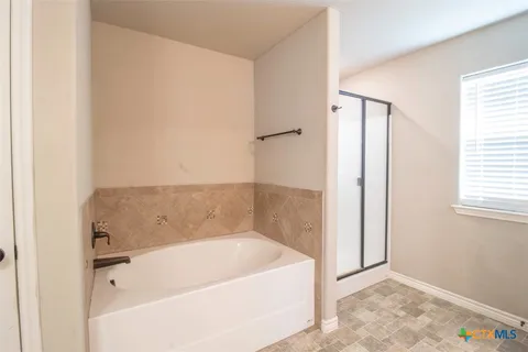 a bathroom with a bathtub and a shower