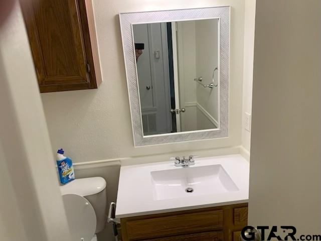 304 Lakeview Street Whitehouse, TX 75791 - Photo 11 of 17 a bathroom with a sink mirror and toilet