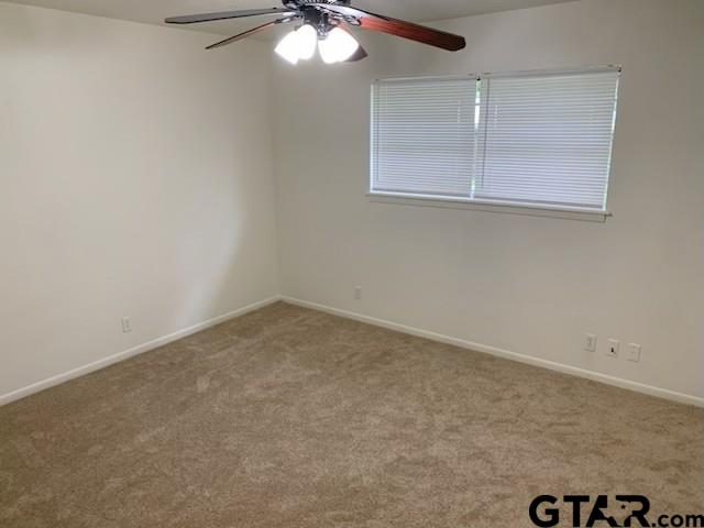 304 Lakeview Street Whitehouse, TX 75791 - Photo 9 of 17 an empty room with a chandelier fan