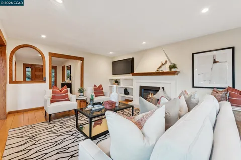 a living room with furniture fireplace and flat screen tv
