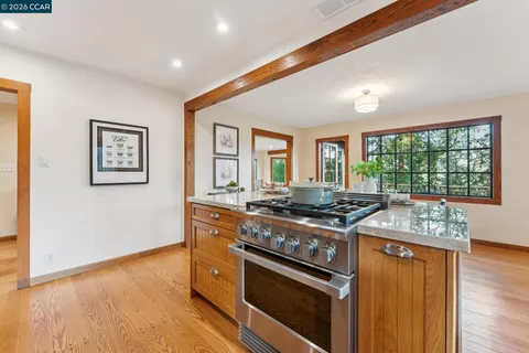 a kitchen with stainless steel appliances granite countertop a stove and a refrigerator