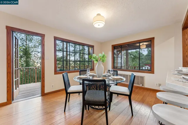 a dining room with furniture a chandelier and wooden floor