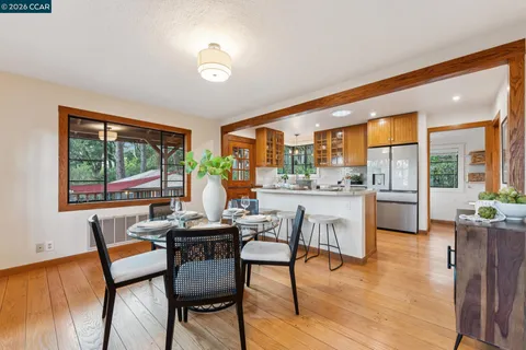 a dining room with furniture and wooden floor