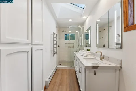 a bathroom with a sink a mirror and a shower