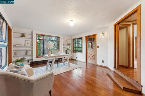 a living room with furniture and large windows