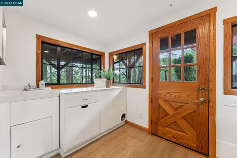 a view of cabinets with wooden floor and window