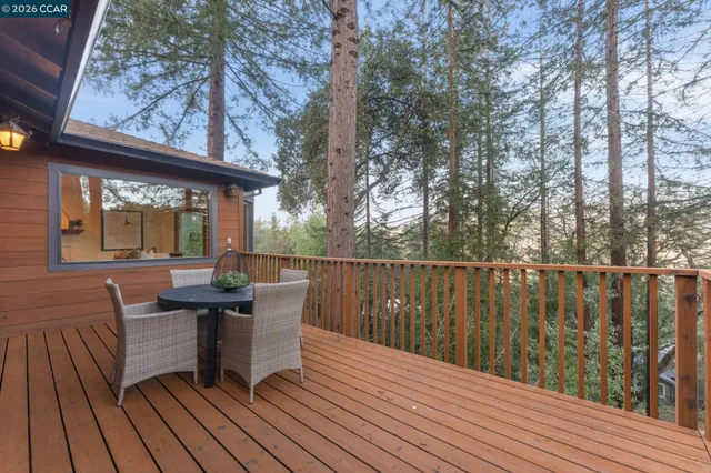 a view of a deck with furniture and wooden floor