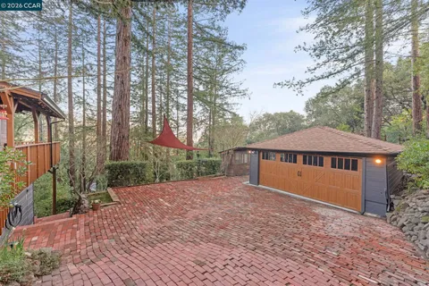 a view of a house with a yard and wooden fence