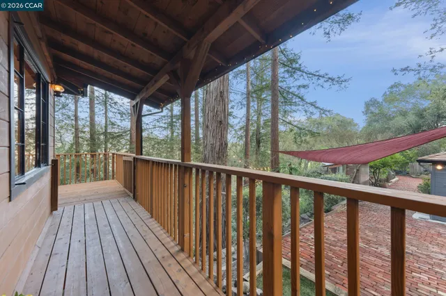 a view of a balcony with wooden floor