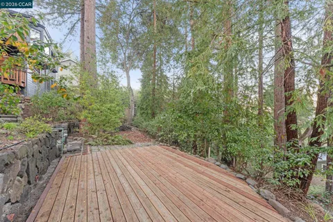 a view of outdoor space and deck with shrubs