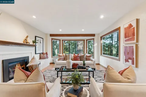 a living room with furniture large window and flat screen tv