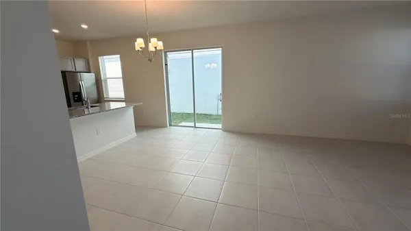 a view of a kitchen with a sink and a refrigerator