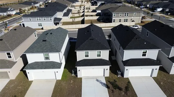 an aerial view of a house with a yard