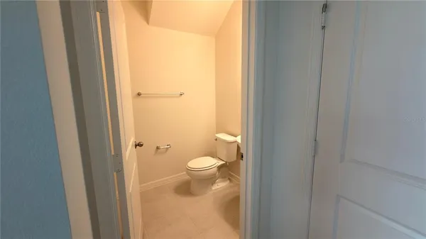 a bathroom with a granite countertop toilet and a sink