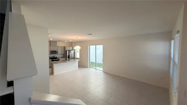 a view of a living room hardwood floor and a kitchen