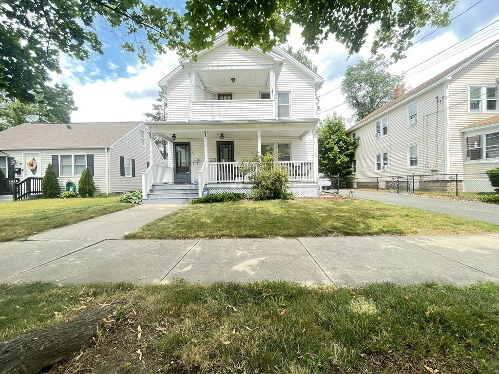 85-87 Windemere Street Springfield, MA 01104 - Photo 2 of 25 a front view of a house with a garden and trees