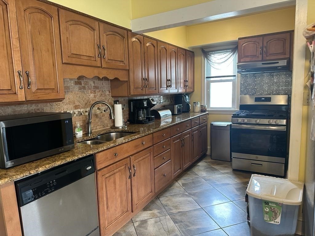 85-87 Windemere Street Springfield, MA 01104 - Photo 8 of 25 a kitchen with a sink appliances and cabinets