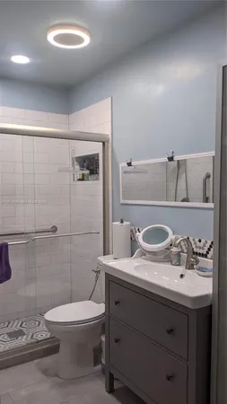 a white toilet sitting next to a white sink