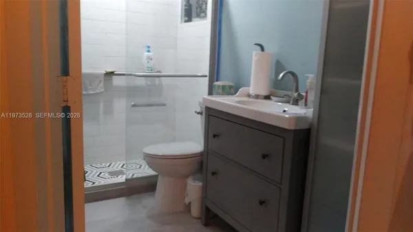 a bathroom with a toilet sink and shower