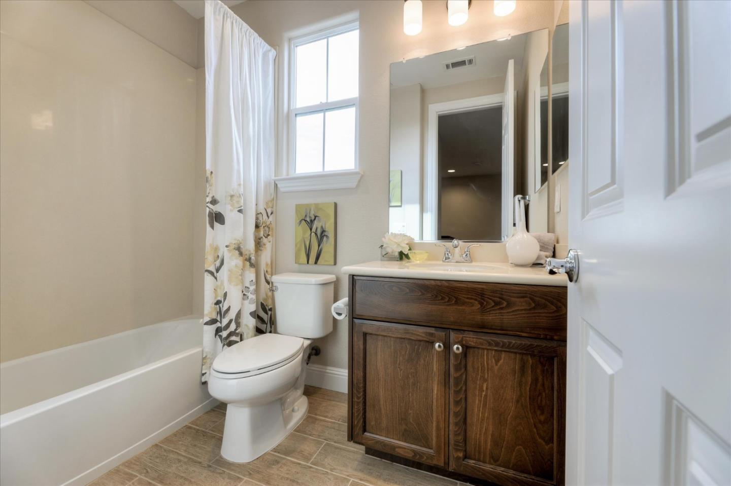 1000 South Monarch Road San Ramon, CA 94582 - Photo 21 of 23 a bathroom with a sink toilet a mirror and shower