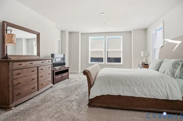 a living room with a bed and dresser