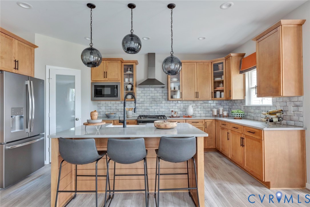 967 Charlemagne Road Midlothian, VA 23114 - Photo 11 of 50 a kitchen with stainless steel appliances a large center island and a refrigerator