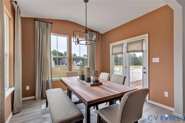 a view of a dining room with furniture and windows