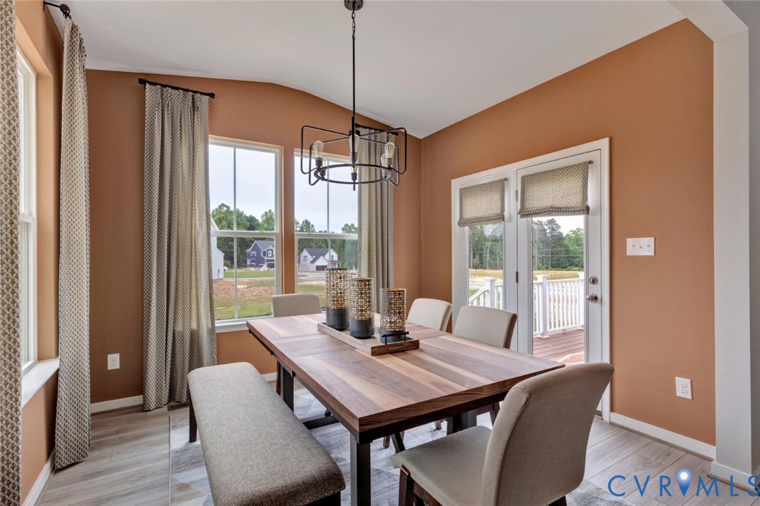 967 Charlemagne Road Midlothian, VA 23114 - Photo 14 of 50 a view of a dining room with furniture wooden floor and a chandelier