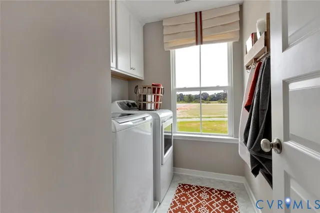 a view of white house with potted plants and a yard