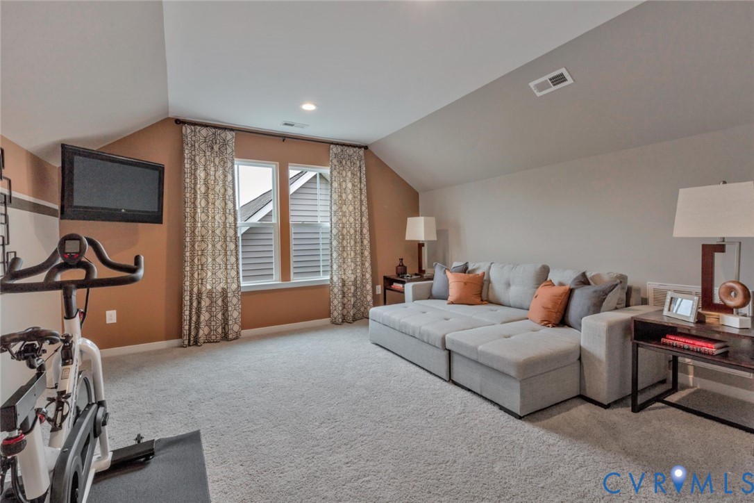 967 Charlemagne Road Midlothian, VA 23114 - Photo 31 of 50 a living room with furniture a flat screen tv and a large window