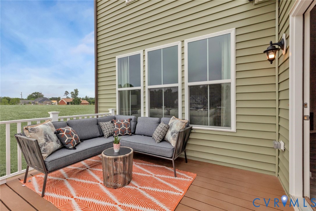 967 Charlemagne Road Midlothian, VA 23114 - Photo 33 of 50 a view of a patio with couches and a potted plant on a table