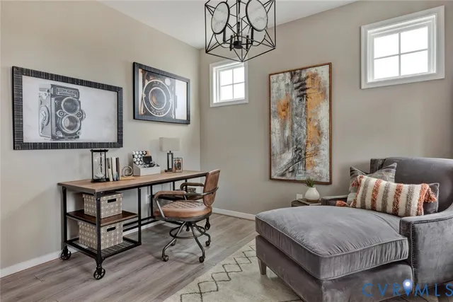 a living room with fireplace furniture and a potted plant
