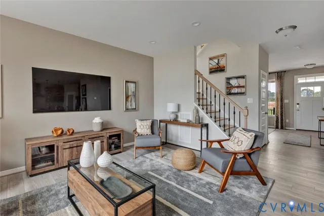 a living room with furniture and wooden floor
