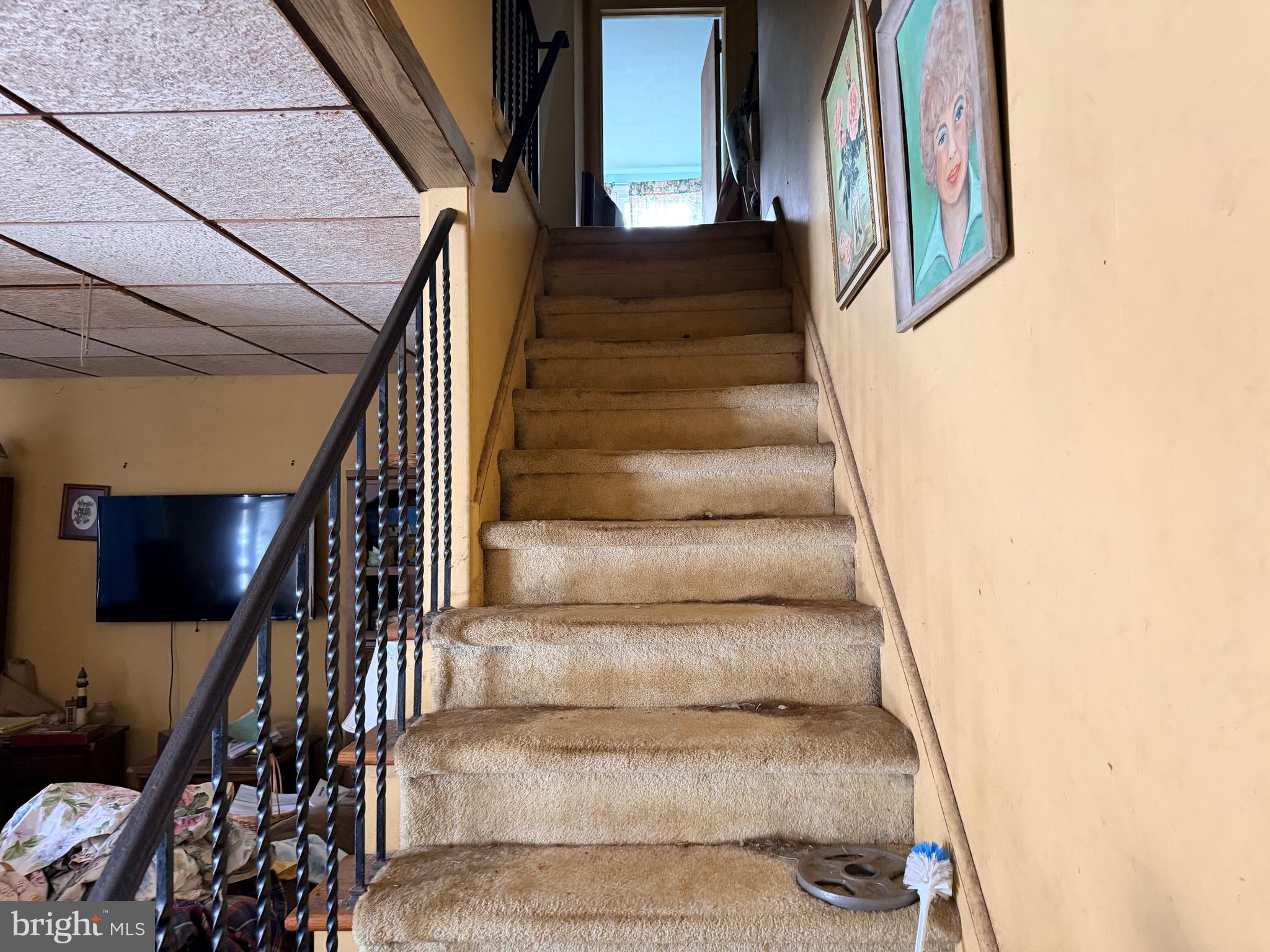 132 Oakdale Road Cherry Hill, NJ 08034 - Photo 12 of 18 a view of staircase with lots of frames on wall and windows