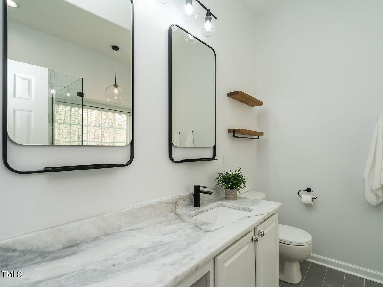 16 Richardson Circle Durham, NC 27713 - Photo 17 of 35 a bathroom with a granite countertop sink and a mirror