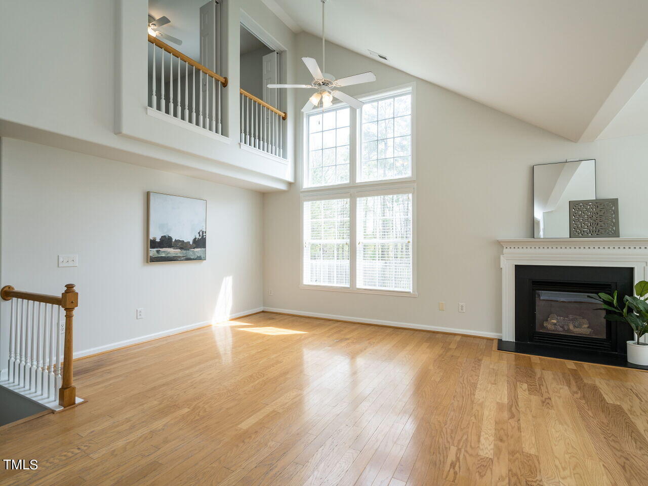 16 Richardson Circle Durham, NC 27713 - Photo 4 of 35 an empty room with wooden floor fireplace and windows